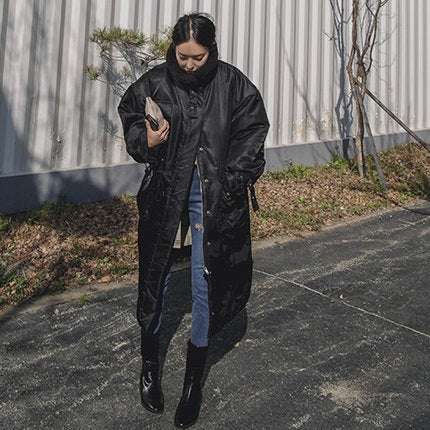 Women's padded longline coat with a high stand-up collar and quilted seams