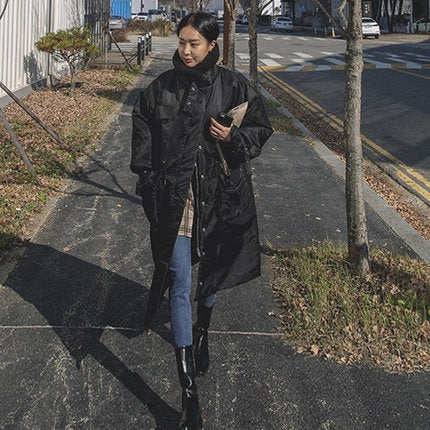 Women's padded longline coat with a high stand-up collar and quilted seams
