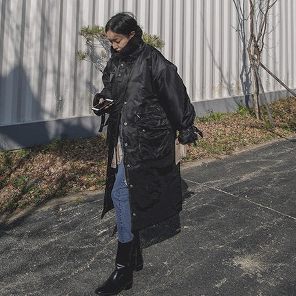 Women's padded longline coat with a high stand-up collar and quilted seams