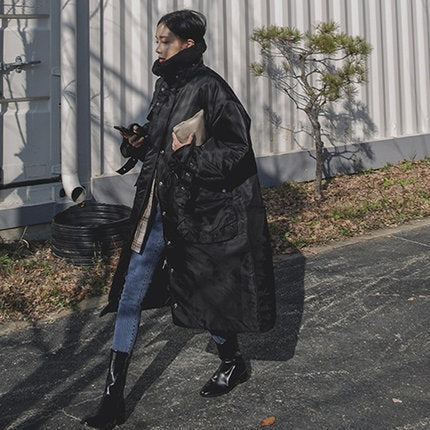 Women's padded longline coat with a high stand-up collar and quilted seams