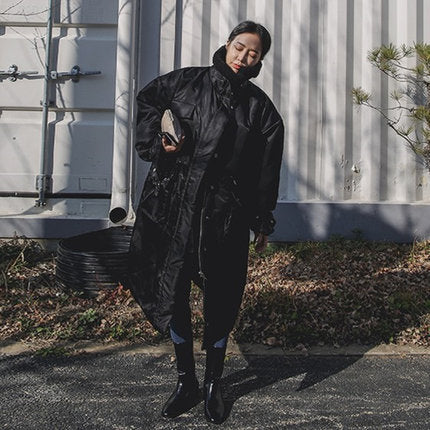 Women's padded longline coat with a high stand-up collar and quilted seams