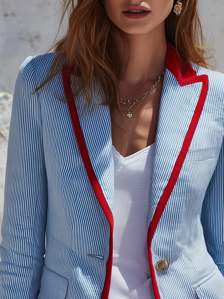 Striped women’s blazer with long sleeves, pockets, and buttons