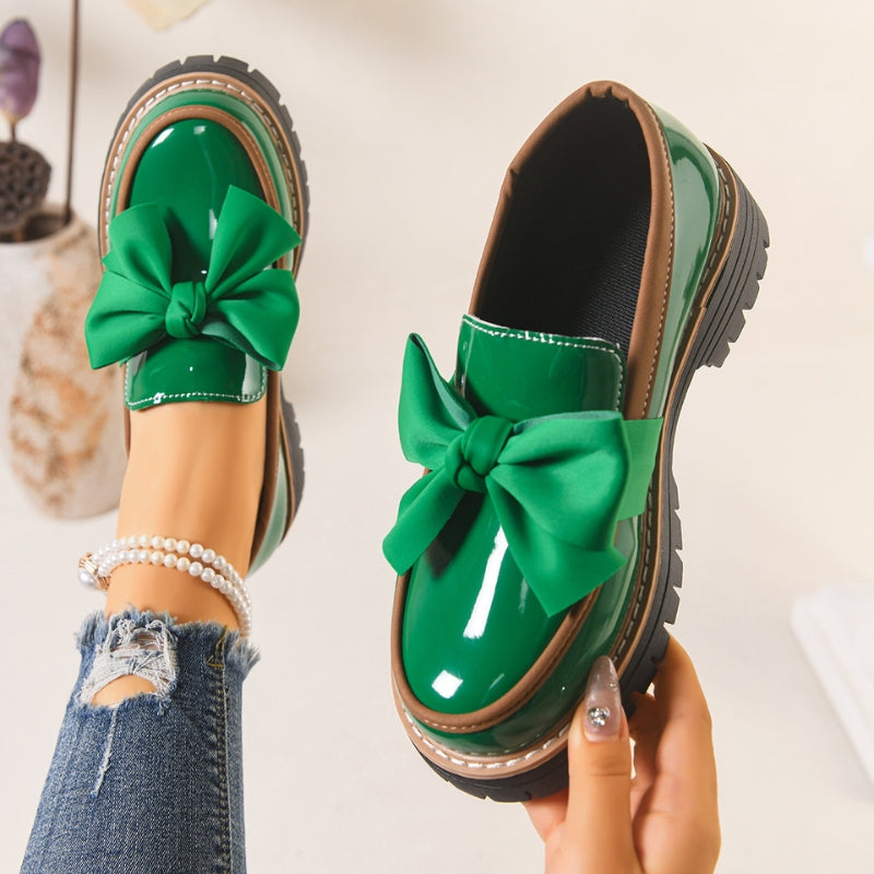 Shiny green loafers with a chunky padded sole
