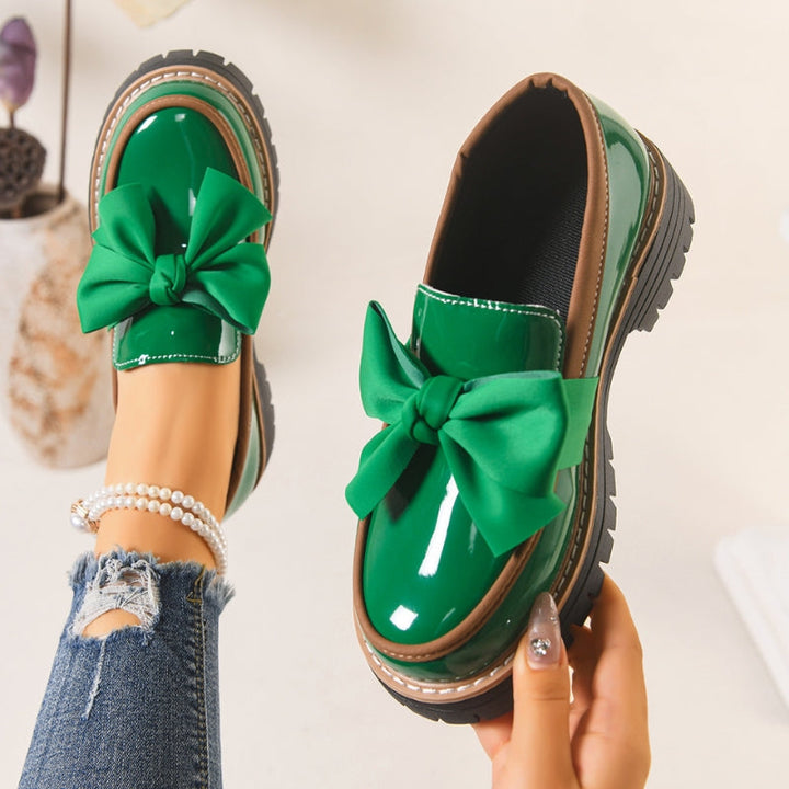 Shiny green loafers with a chunky padded sole