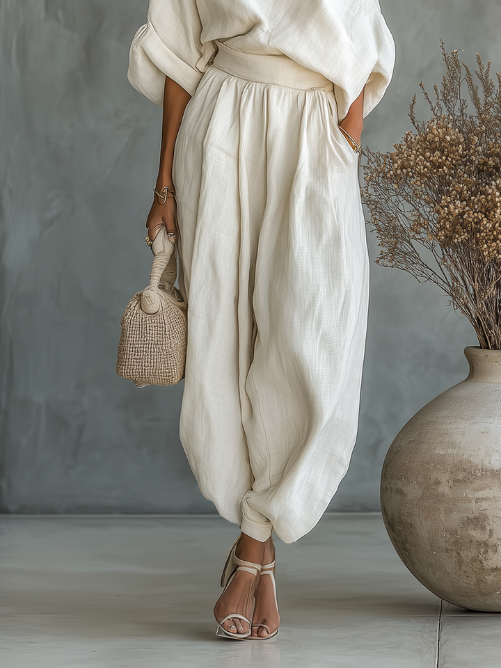 Set of off-the-shoulder, loose-fit women's blouse and slim-fit trousers