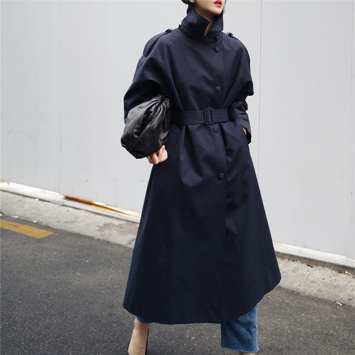 Women’s maxi-length trench coat with a high stand-up collar and waist belt