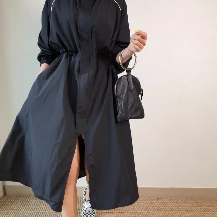 Women's lightweight windbreaker coat with a drawstring waist and raglan sleeves