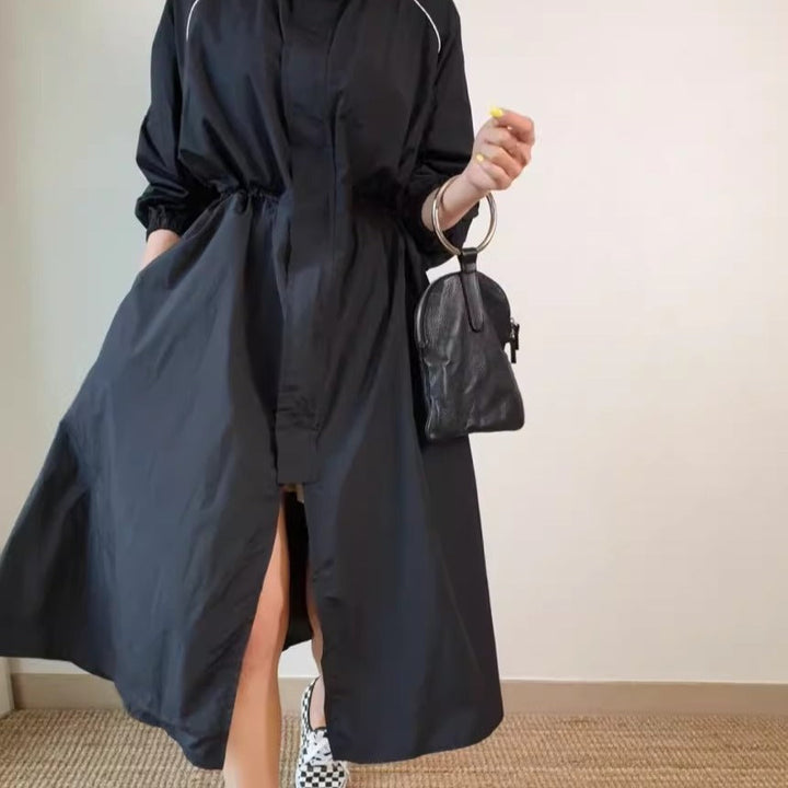 Women's lightweight windbreaker coat with a drawstring waist and raglan sleeves