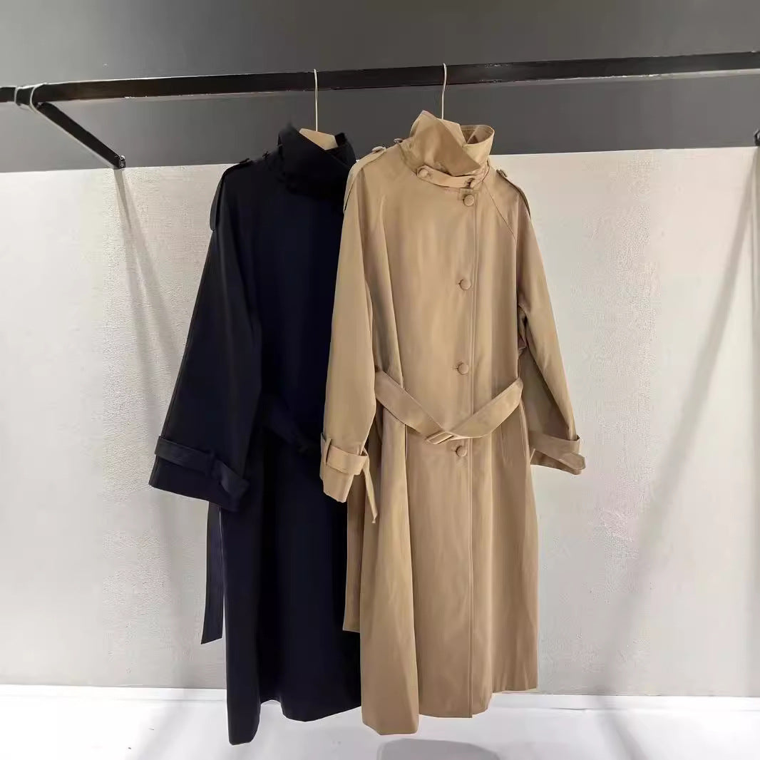 Women’s maxi-length trench coat with a high stand-up collar and waist belt