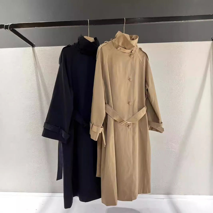 Women’s maxi-length trench coat with a high stand-up collar and waist belt
