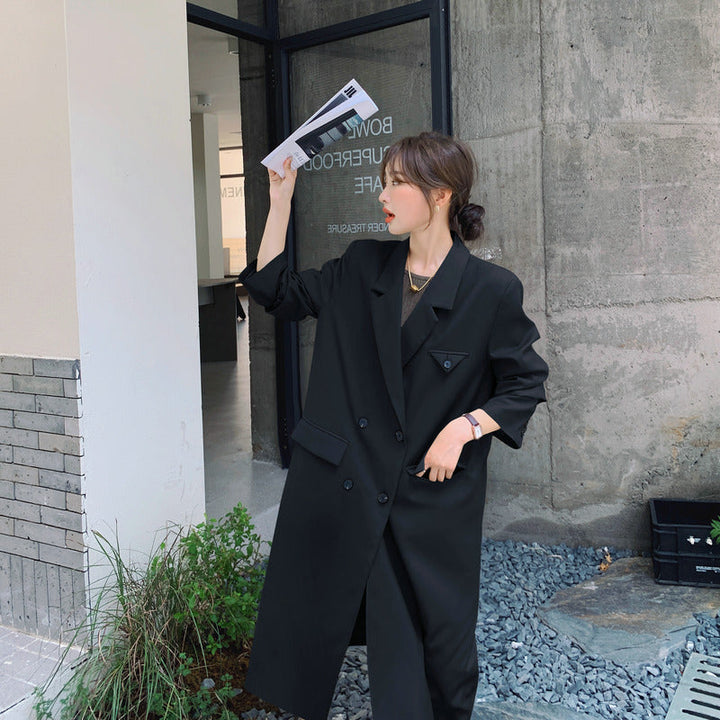 Women’s double-breasted oversized trench coat with lapels and an elongated cut