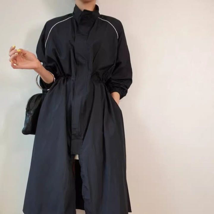 Women's lightweight windbreaker coat with a drawstring waist and raglan sleeves