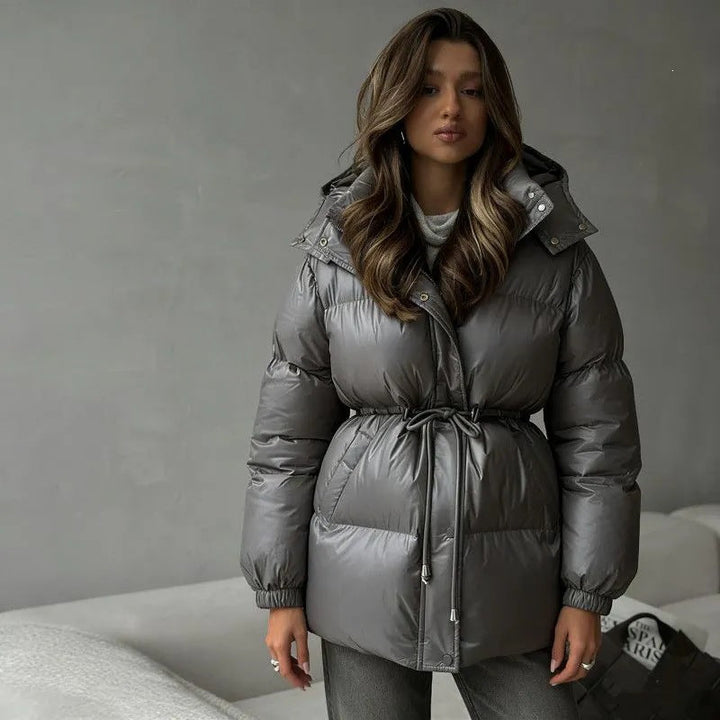 Women's hooded jacket with an adjustable waist drawstring and glossy finish