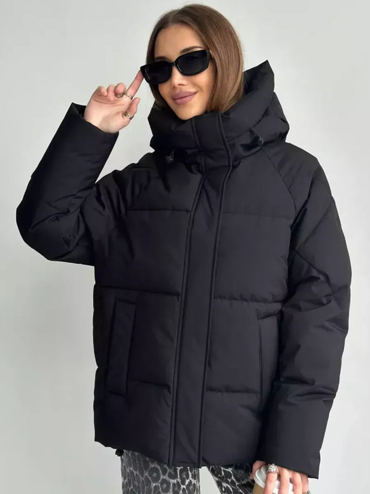 Women's oversized quilted jacket with a hood and integrated pockets