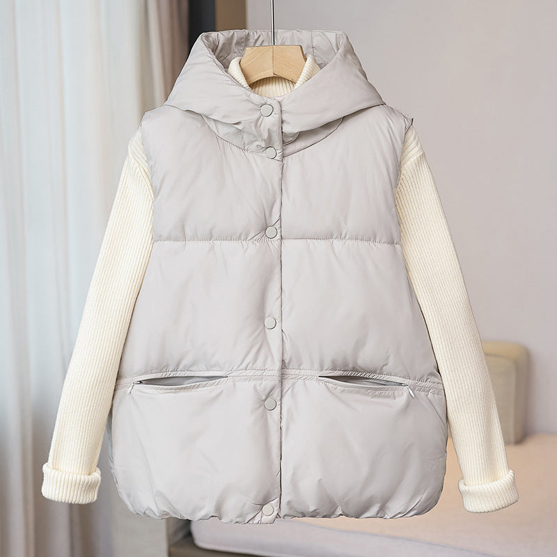 Women's padded sleeveless quilted vest with a voluminous stand collar and zippered pockets