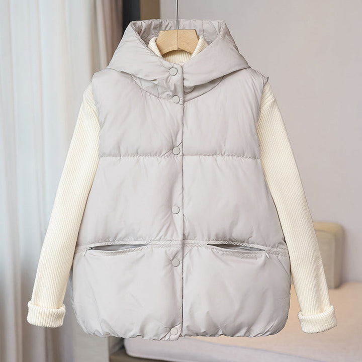 Women's padded sleeveless quilted vest with a voluminous stand collar and zippered pockets