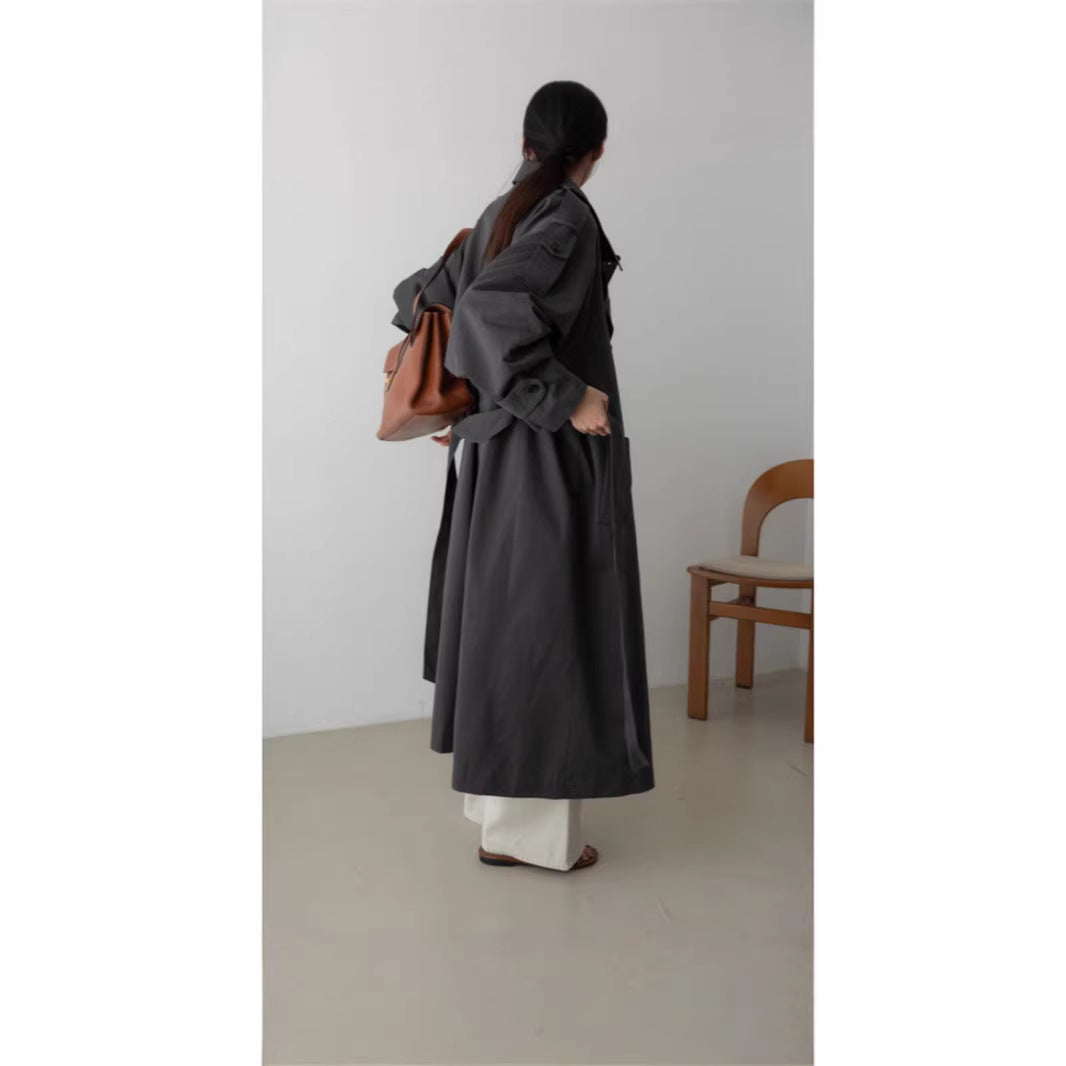 Women's oversized maxi-length trench coat with waist belt and epaulettes