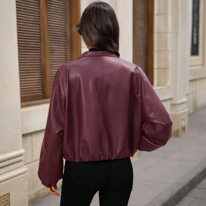Women's cropped faux leather jacket with zippered pockets and a fitted cut