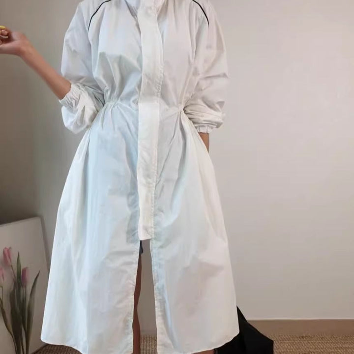 Women's lightweight windbreaker coat with a drawstring waist and raglan sleeves