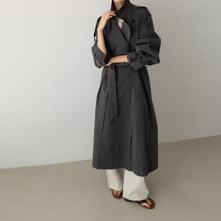 Women's oversized maxi-length trench coat with waist belt and epaulettes
