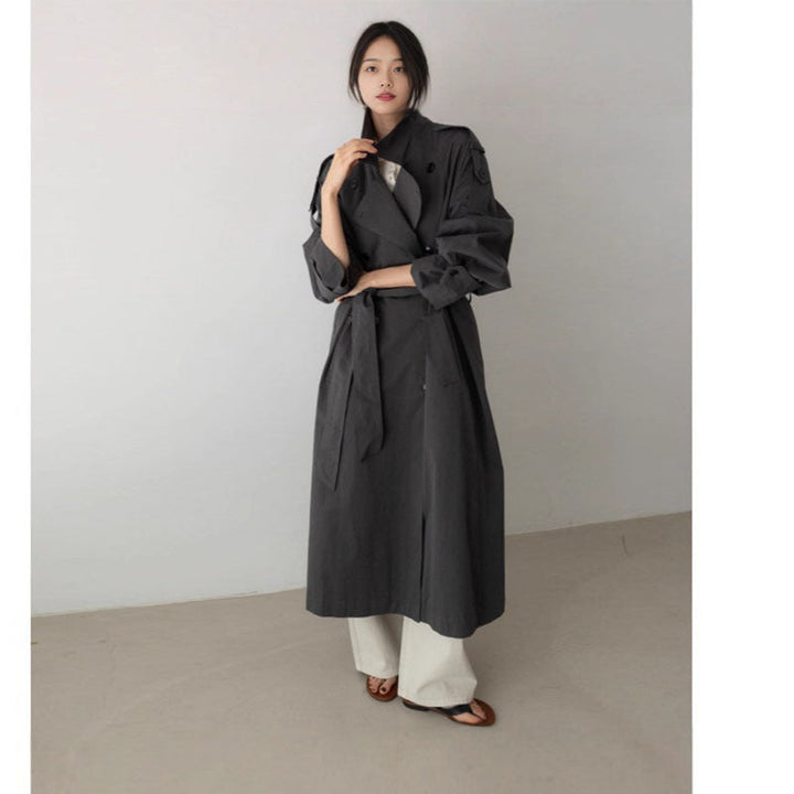 Women's oversized maxi-length trench coat with waist belt and epaulettes