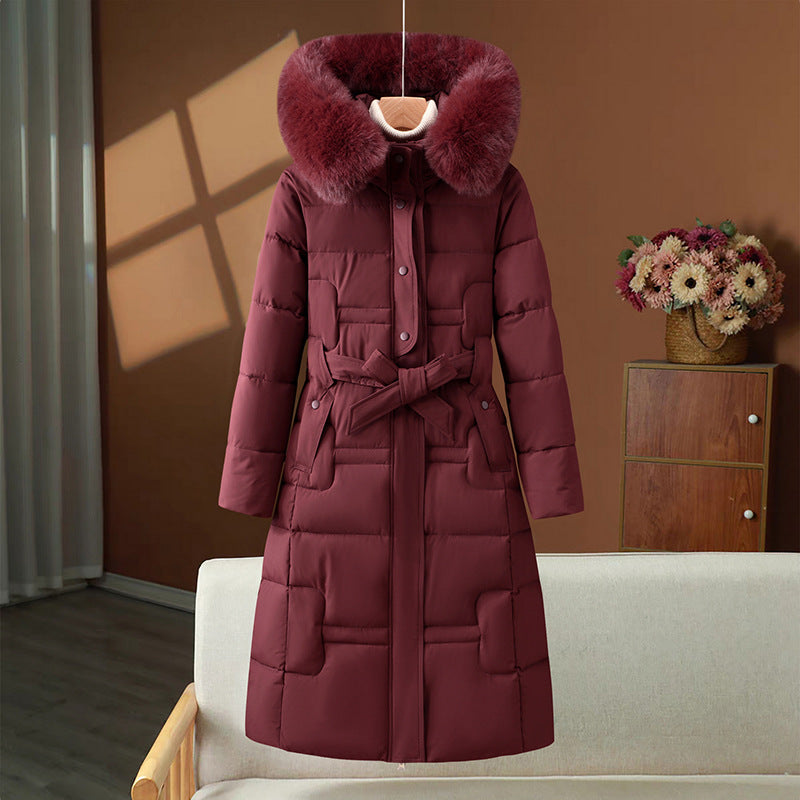 Women’s long quilted winter coat with detachable faux-fur collar and waist belt