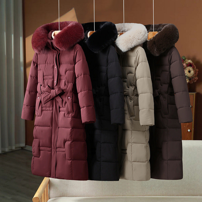 Women’s long quilted winter coat with detachable faux-fur collar and waist belt