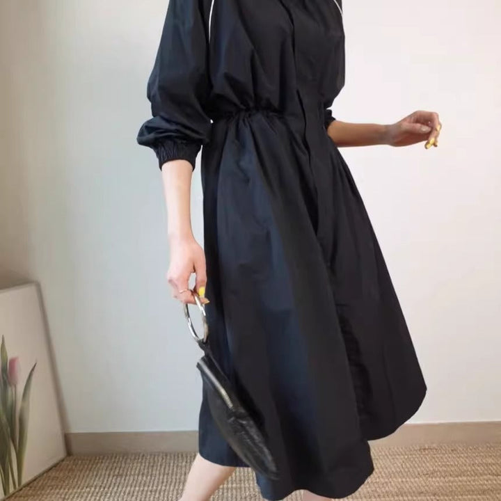 Women's lightweight windbreaker coat with a drawstring waist and raglan sleeves