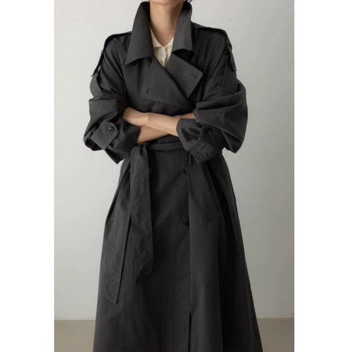 Women's oversized maxi-length trench coat with waist belt and epaulettes