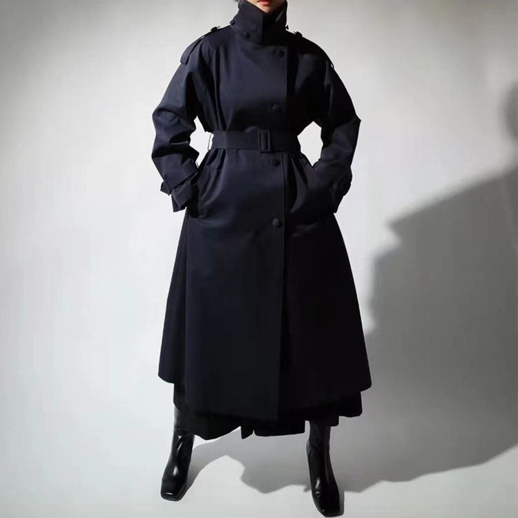 Women’s maxi-length trench coat with a high stand-up collar and waist belt