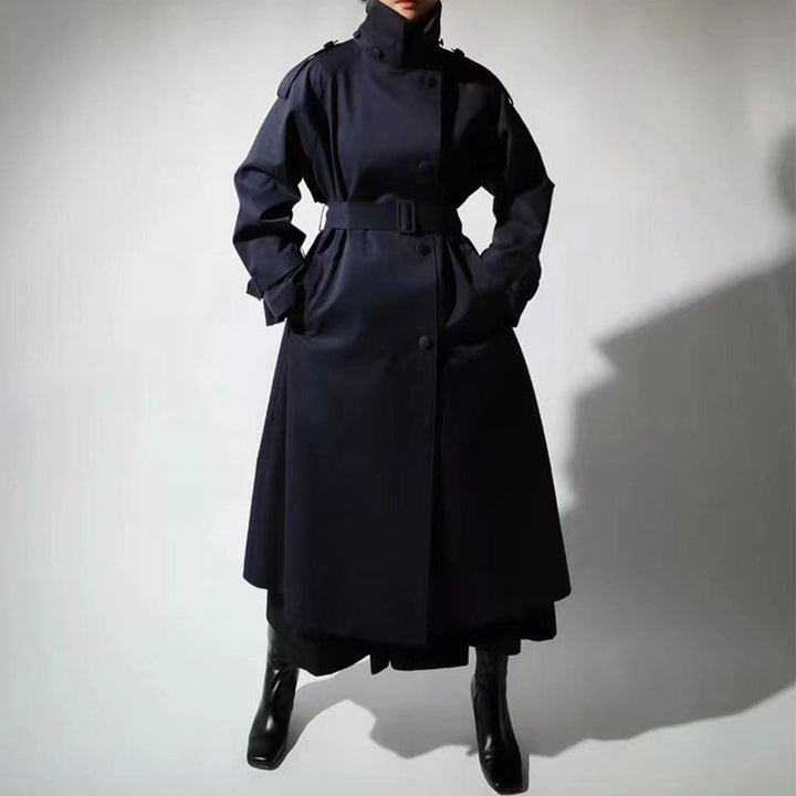 Women’s maxi-length trench coat with a high stand-up collar and waist belt