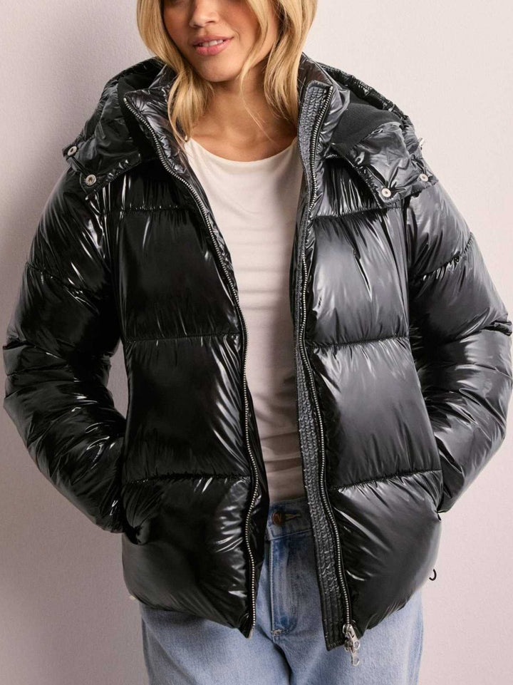 Women's quilted jacket with an adjustable hood and zippered pockets