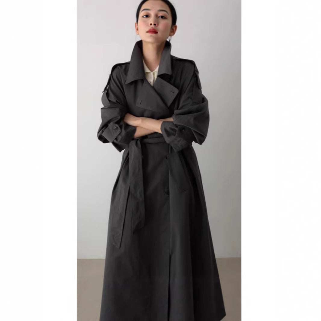 Women's oversized maxi-length trench coat with waist belt and epaulettes