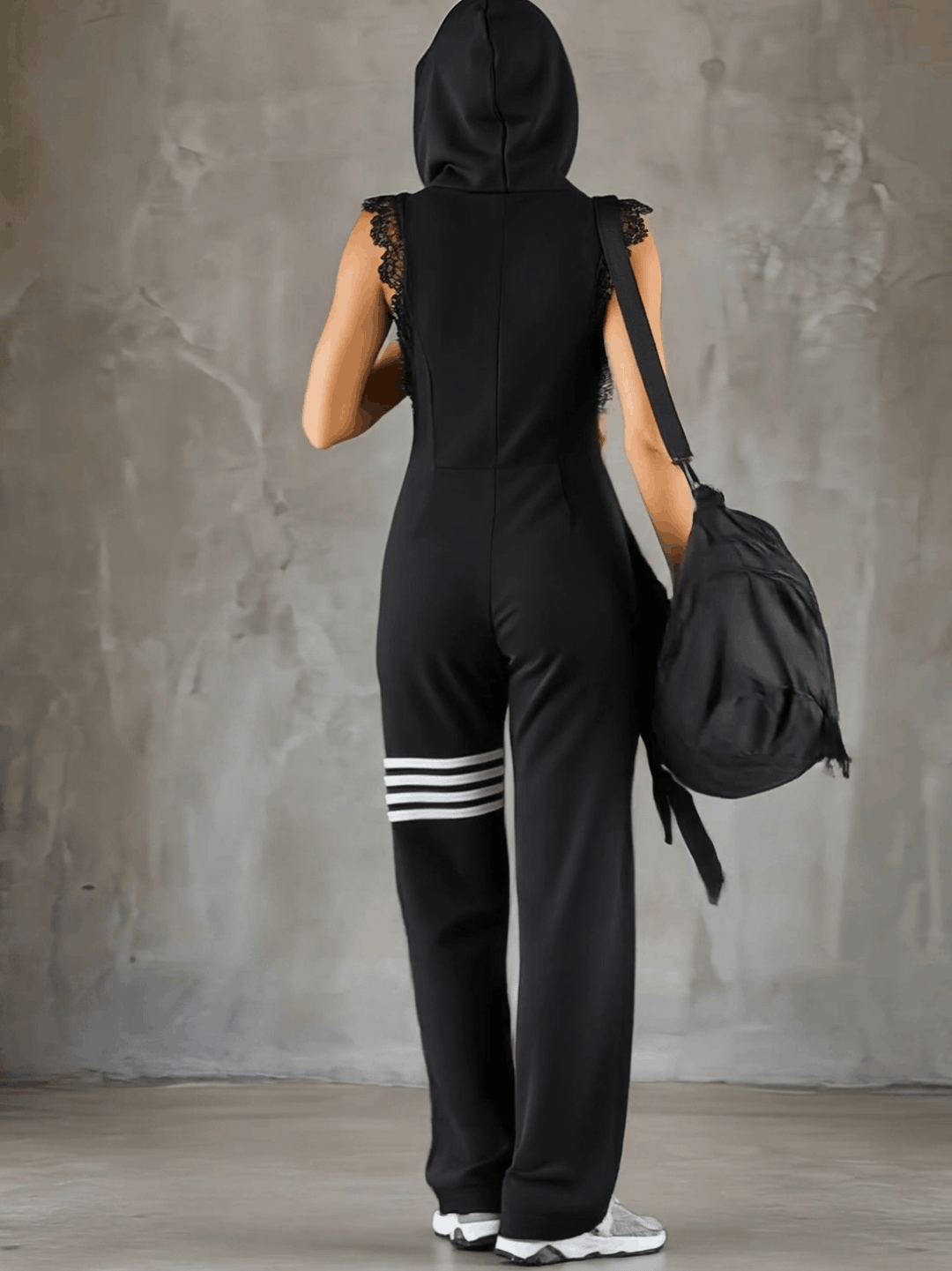 Retro-inspired black sleeveless hooded jumpsuit with sporty lace-up stripes