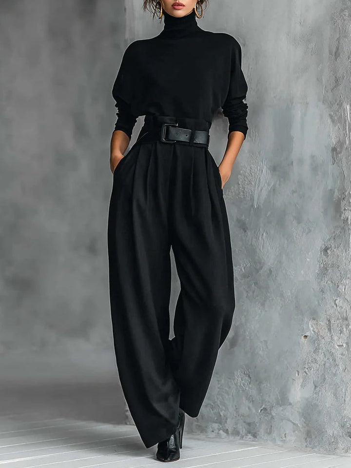 Black long-sleeved turtleneck top and straight-cut trousers with a belt