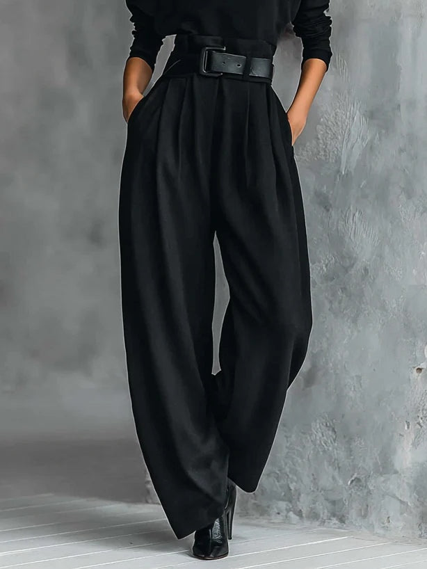 Black long-sleeved turtleneck top and straight-cut trousers with a belt