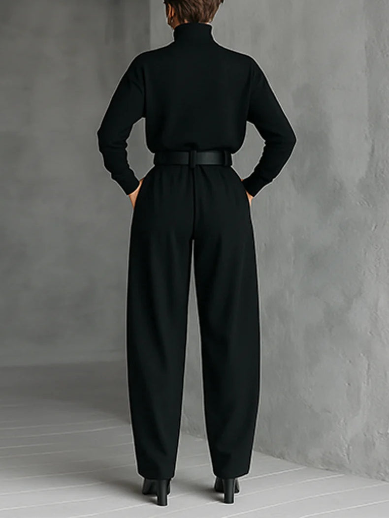 Black long-sleeved turtleneck top and straight-cut trousers with a belt
