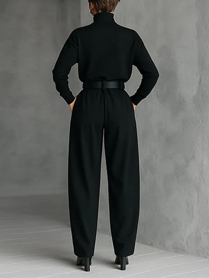 Black long-sleeved turtleneck top and straight-cut trousers with a belt