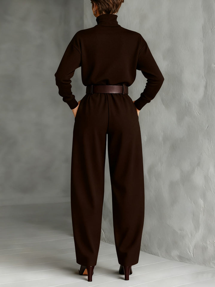 Black long-sleeved turtleneck top and straight-cut trousers with a belt