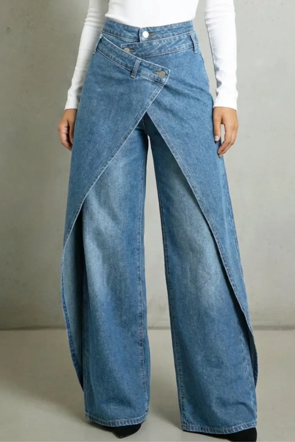 Vintage-inspired high-waisted denim jeans with a ruffled waistband and tie belt