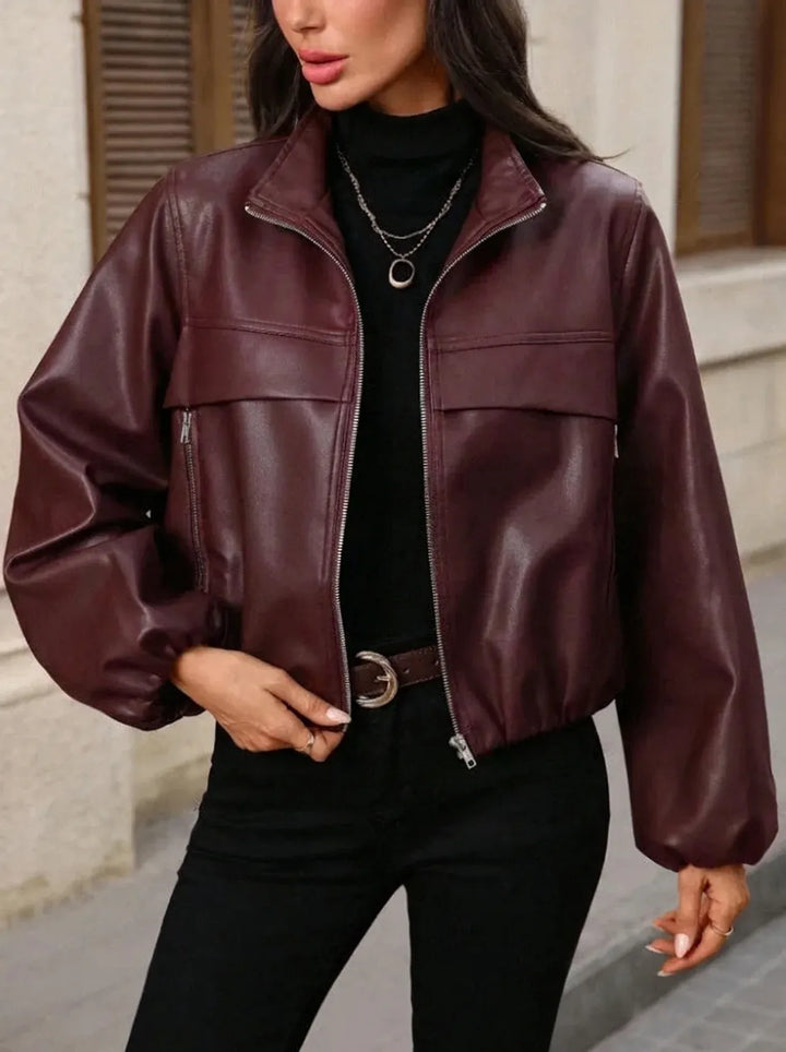 Women's cropped faux leather jacket with zippered pockets and a fitted cut