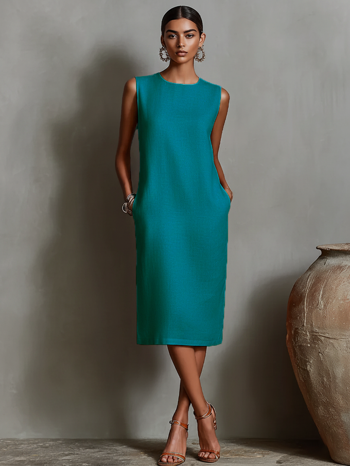 Women's orange sheath dress with sleeveless crew neck and side pockets, timeless minimalist-elegant style